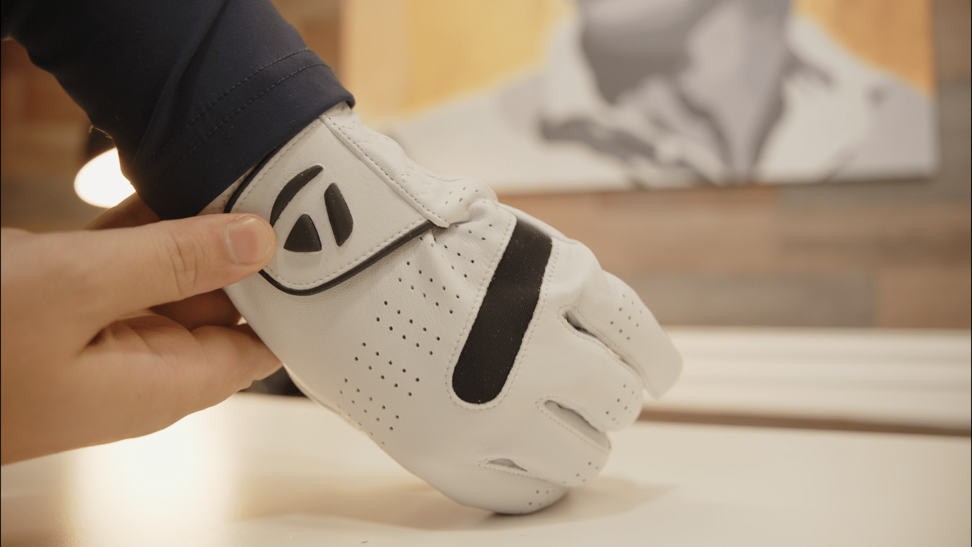 Close-up of person adjusting white golf glove