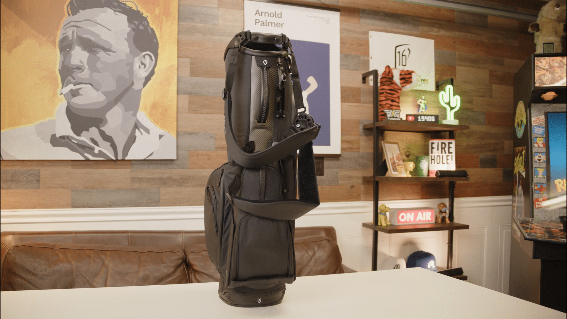 Black golf bag displayed on studio table