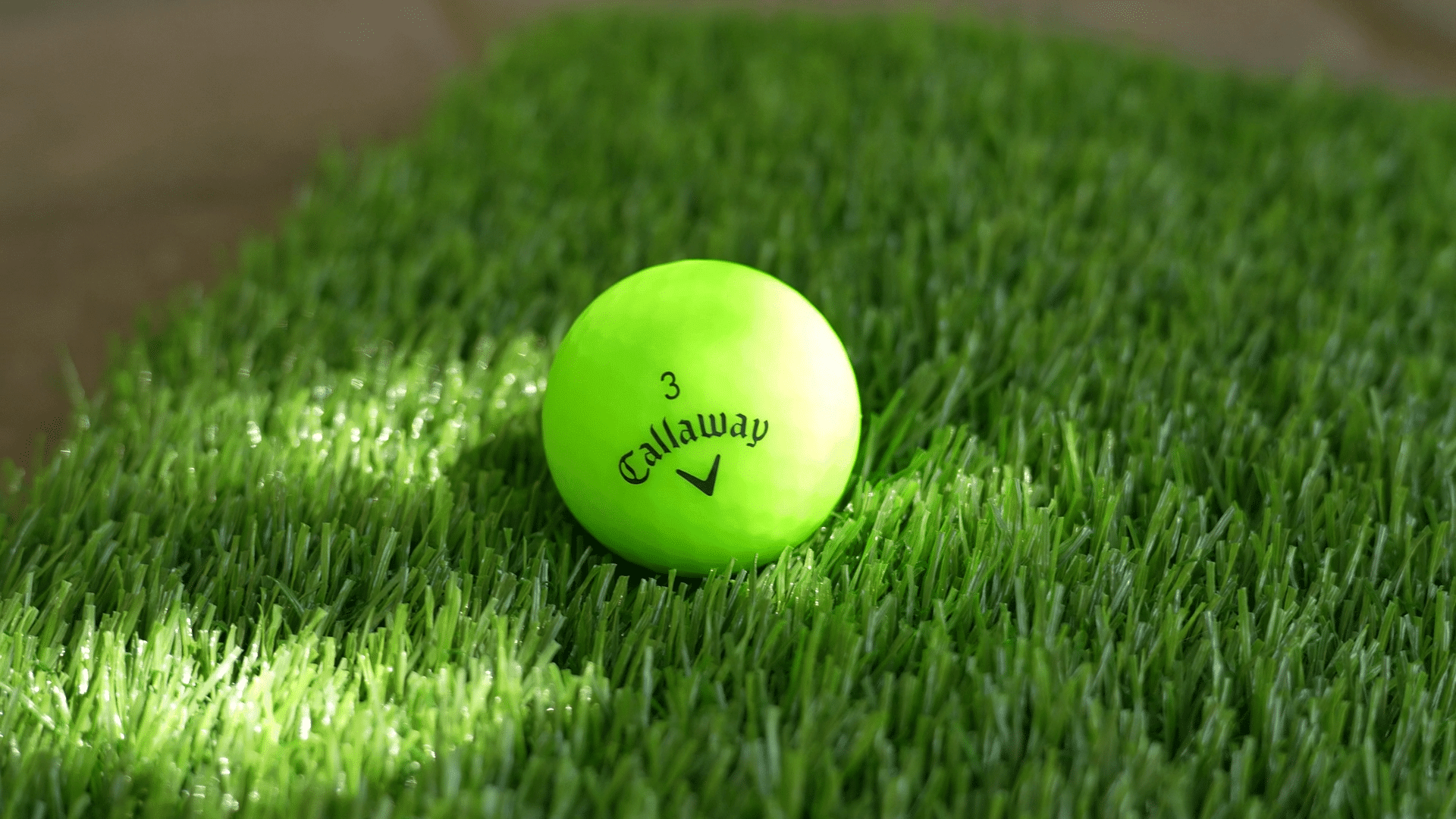 Bright green Callaway golf ball on grass