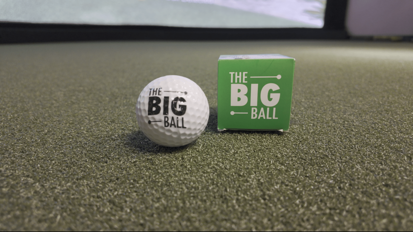 Golf ball and green box on turf