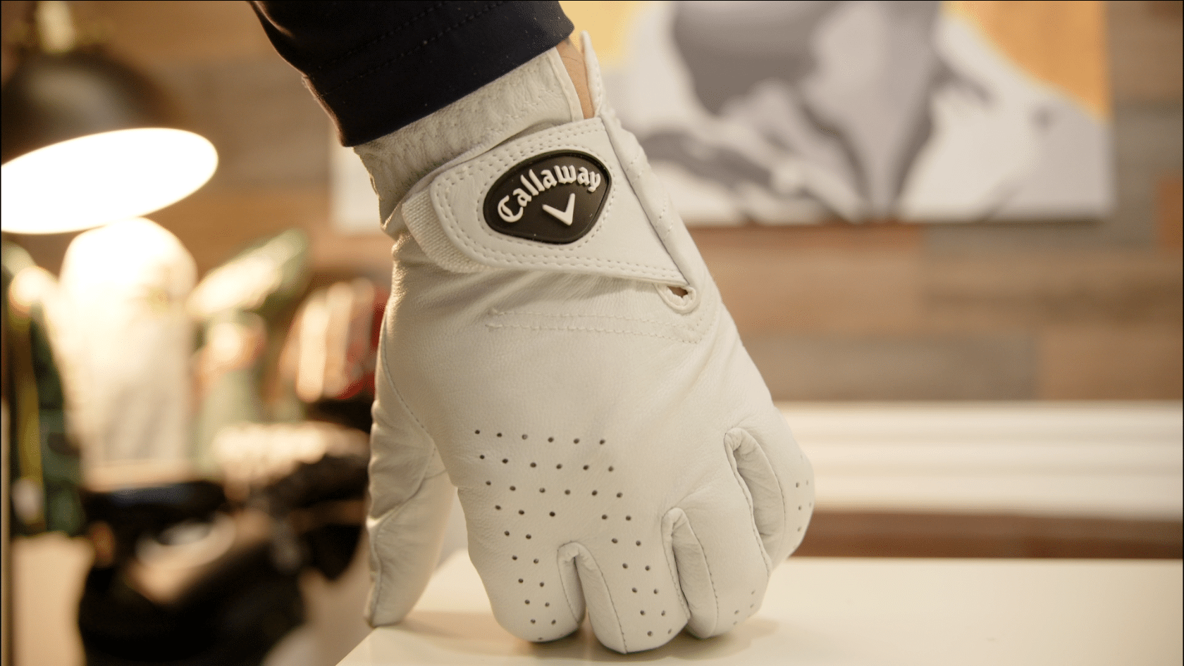 Close-up of white Callaway golf glove on hand