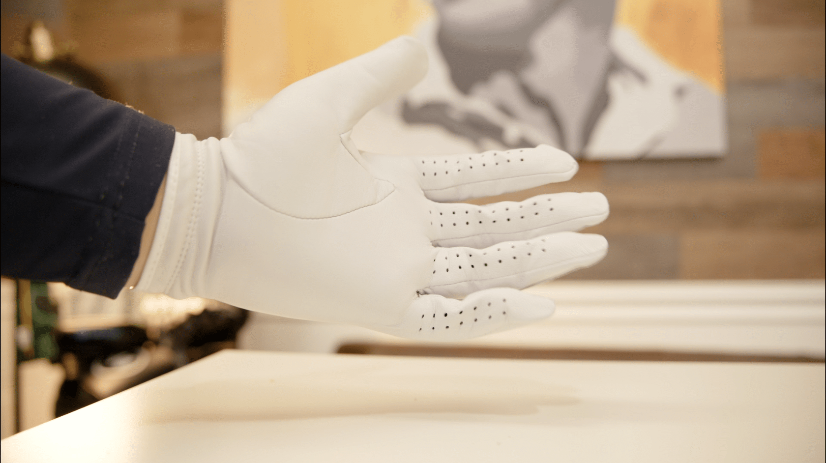 Close-up of hand wearing white golf glove