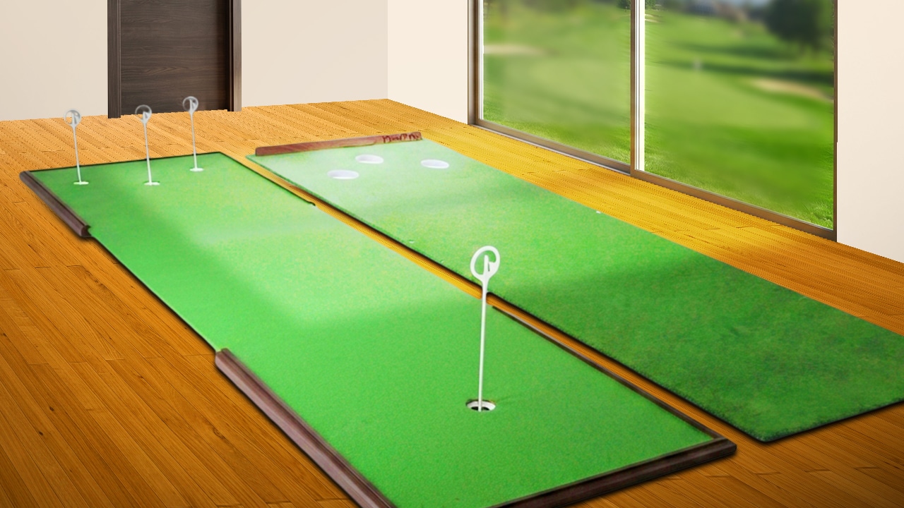 Indoor putting greens beside large windows overlooking lawn