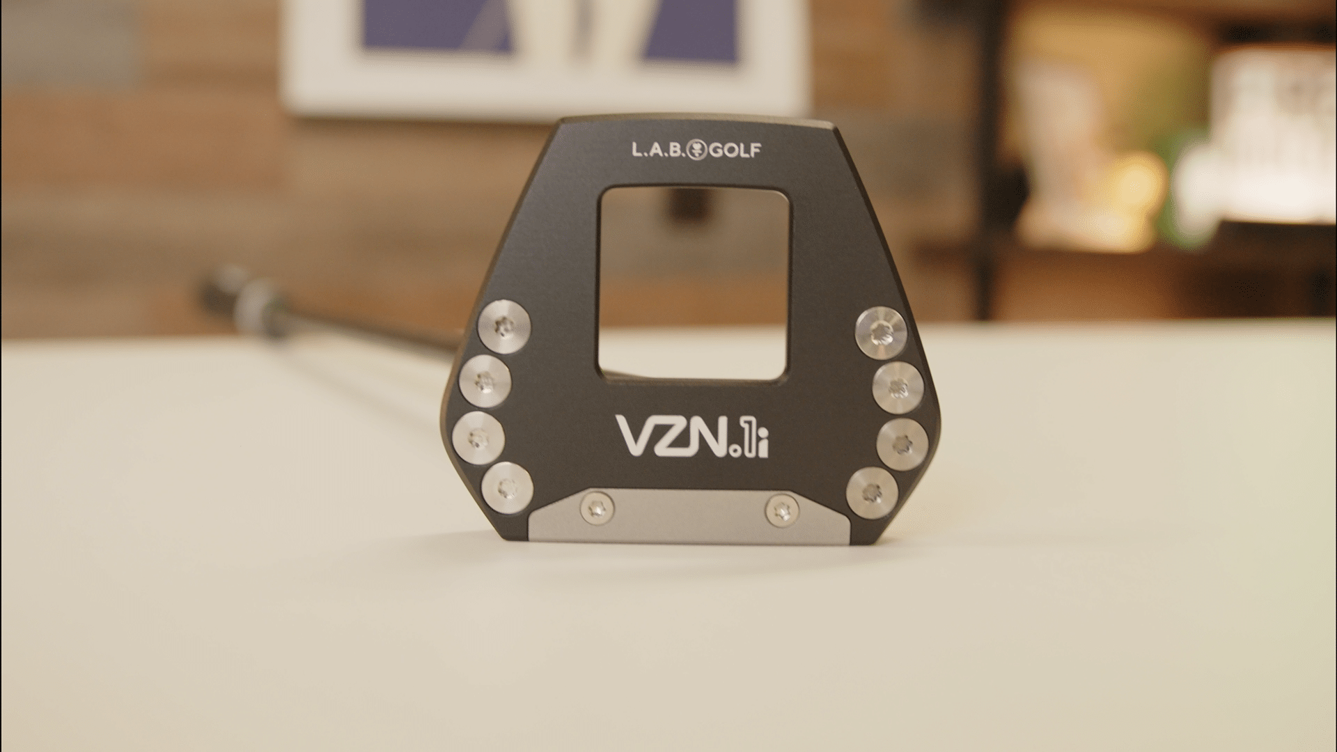 L.A.B. Golf VZN.i putter head on a tabletop