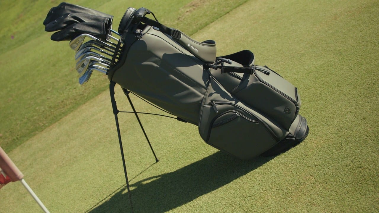Gray Vessel Player VI Pro loaded with a full set of clubs, standing on its legs on the golf course
