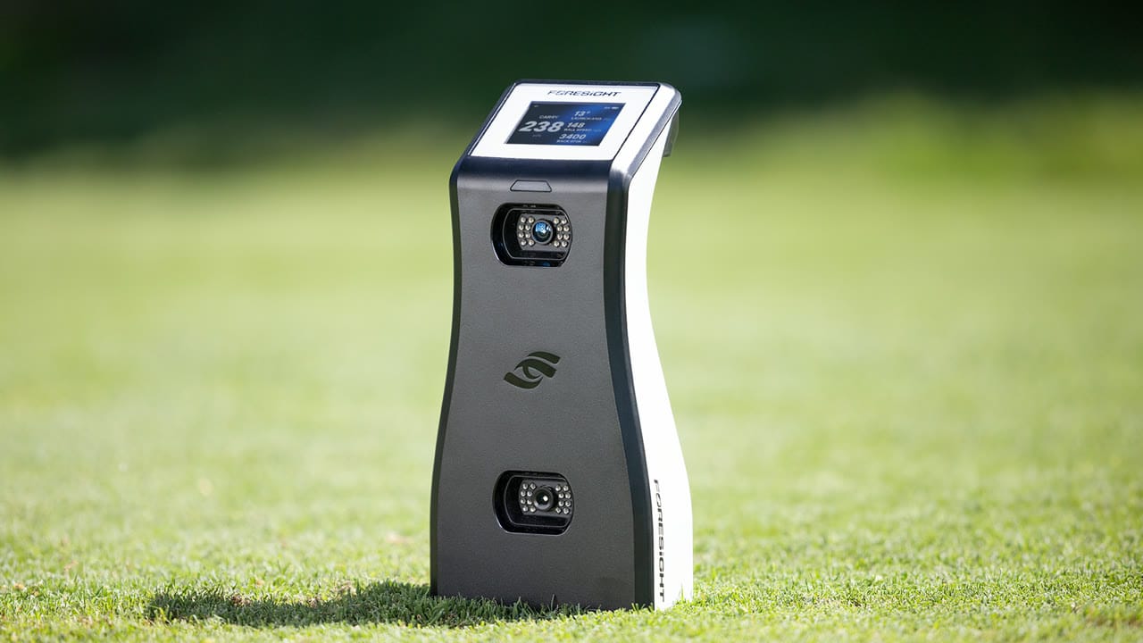 Foresight GC2 launch monitor on grass with ball data on its color screen